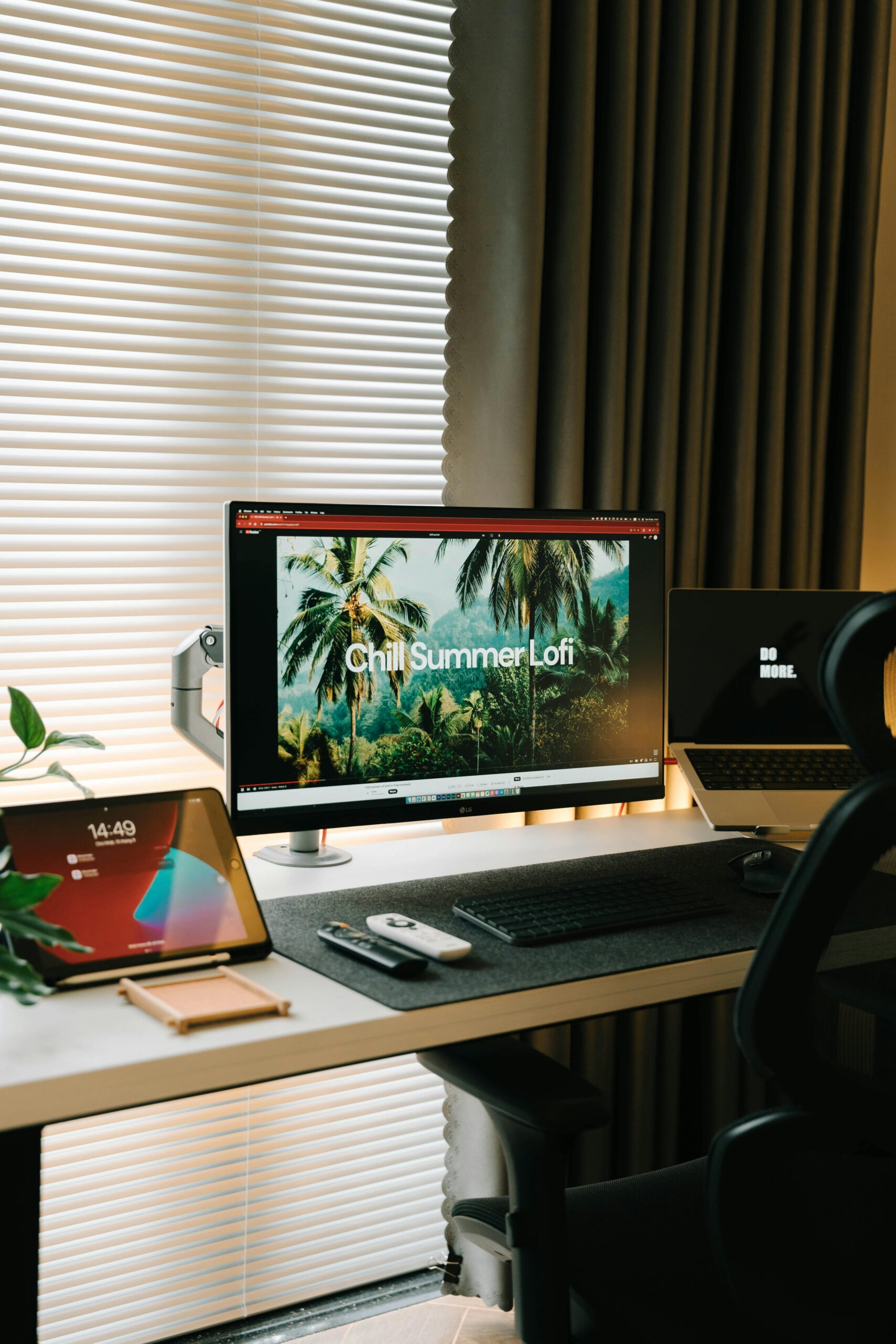 Stylish home office with dual monitors, tablet, and modern design elements.